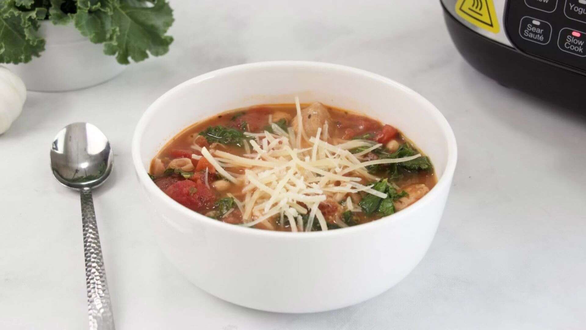 Bowl of slow Cooker Kale, White Bean, and Sausage Soup.
